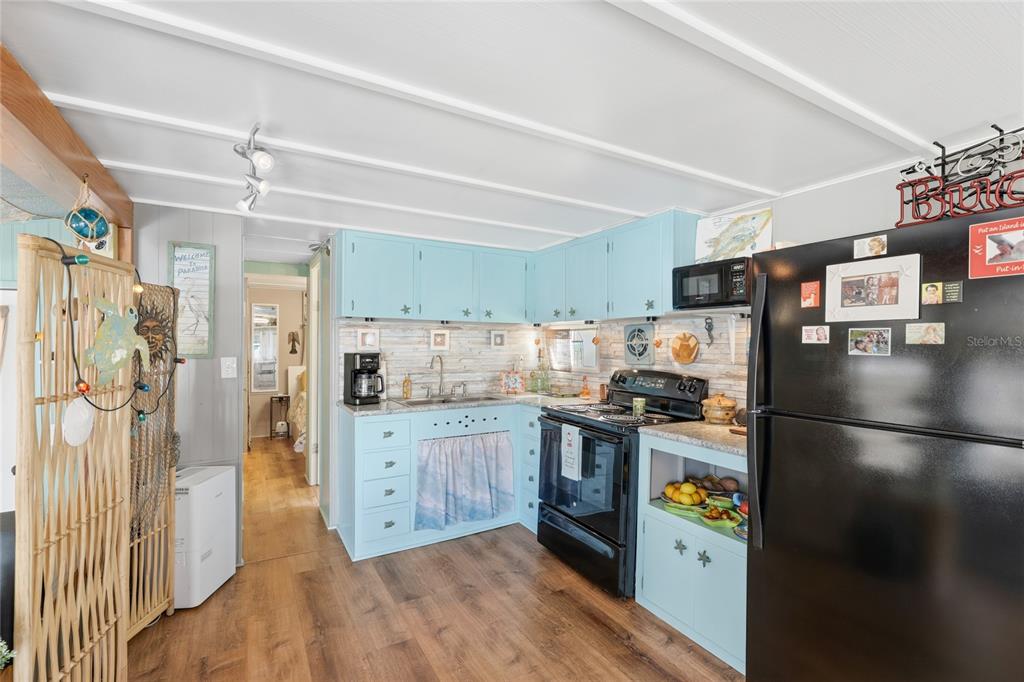 10315 Cortez Road West, Unit 142 Bradenton, FL 34210 - Photo 6 of 22 a kitchen with stainless steel appliances granite countertop a refrigerator a stove and a sink