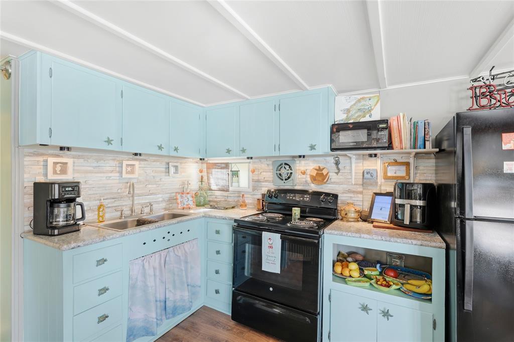 10315 Cortez Road West, Unit 142 Bradenton, FL 34210 - Photo 7 of 22 a kitchen with stainless steel appliances a stove a sink and cabinets