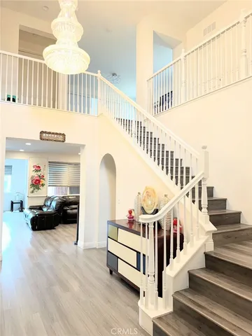 a view of entryway livingroom and hall with wooden floor