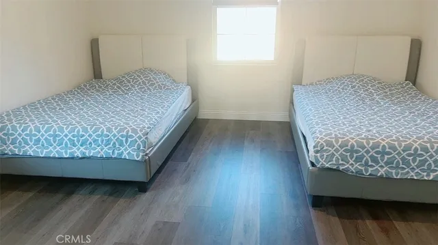 a bedroom with wooden floor