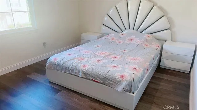 a bed sitting in a bedroom next to a window