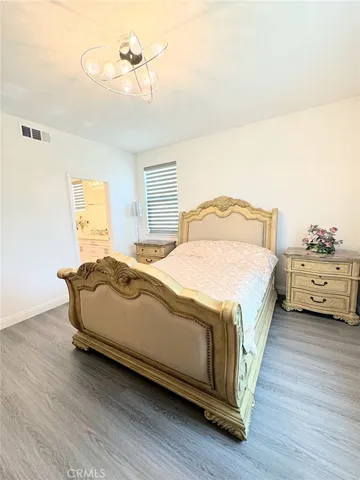 a bedroom with a bed and a night stand