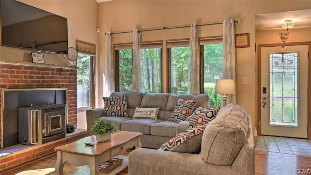 1017 Clover Road Long Pond, PA 18334 - Photo 8 of 45 a living room with furniture a flat screen tv and a fireplace