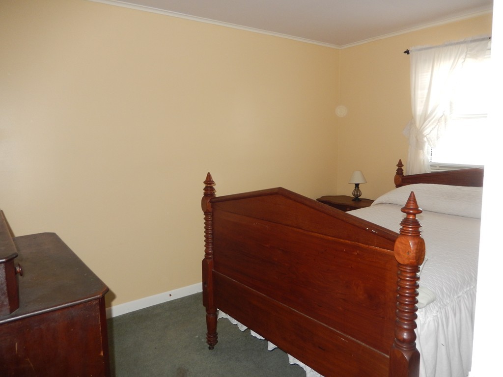10 Hospital Road Monson, MA 01057 - Photo 11 of 17 a bed sitting in a bedroom next to a window