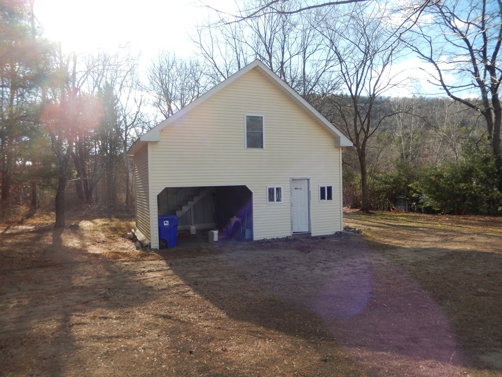 10 Hospital Road Monson, MA 01057 - Photo 14 of 17 a view of a house with a yard and garage
