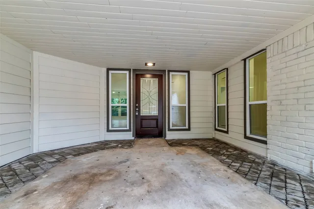 an empty room with wooden floor and a ceiling fan