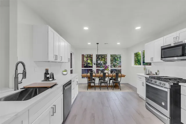 a kitchen with lots of counter top space and stainless steel appliances