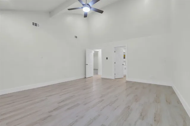 a view of a kitchen with wooden floor and windows