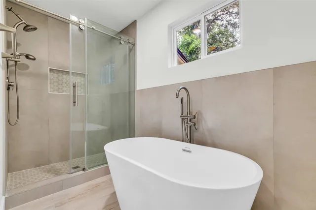 a view of an empty room with a chandelier fan