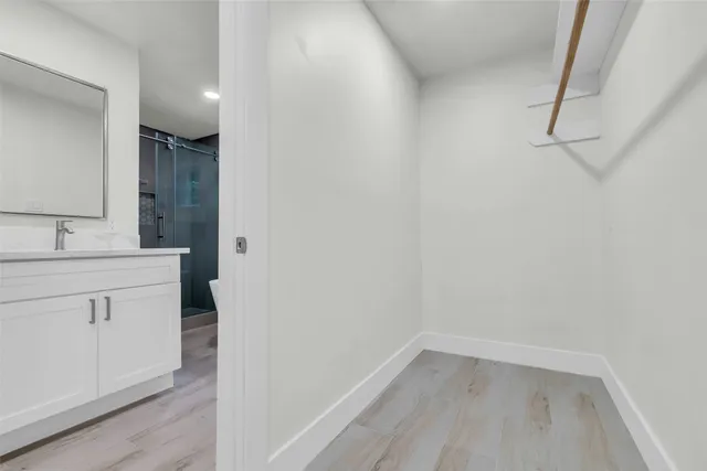 a spacious bathroom with a double vanity sink mirror and toilet
