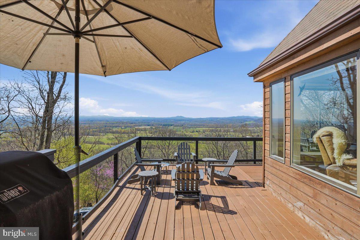 19897 Foresthill Road Bluemont, VA 20135 - Photo 7 of 39 a view of a balcony with chairs and wooden floor