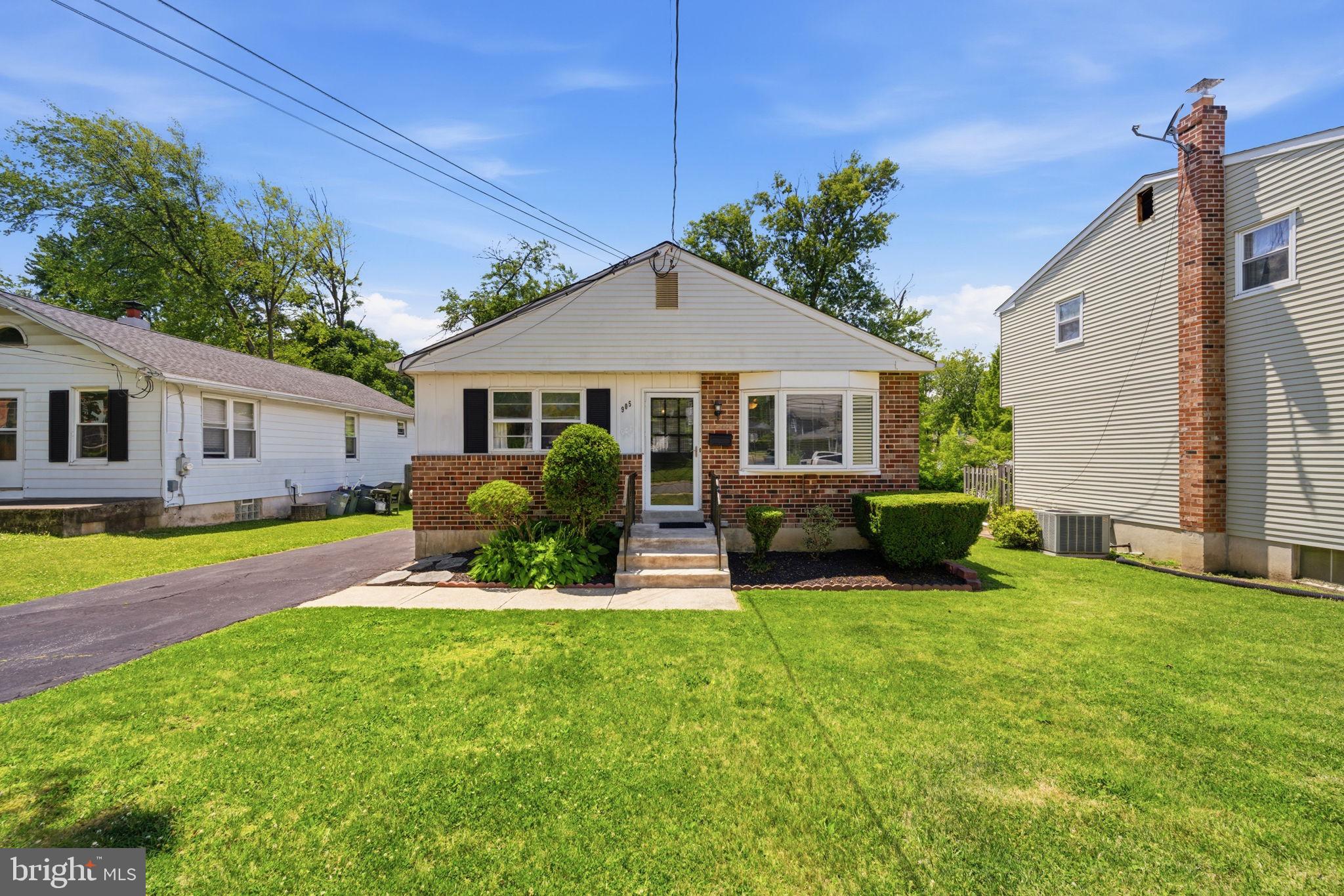 905 Amosland Road Morton, PA 19070 - Photo 2 of 44 Charming brick home with lush greenery.