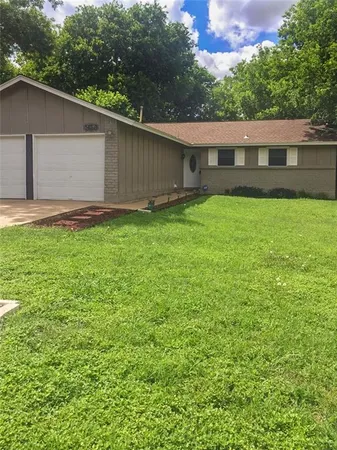 a view of a house with a backyard