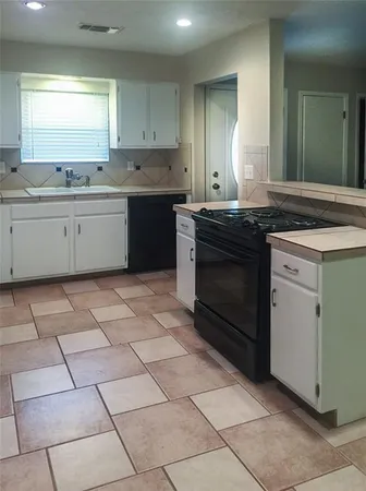 a kitchen with stainless steel appliances granite countertop a stove a sink and a counter top space