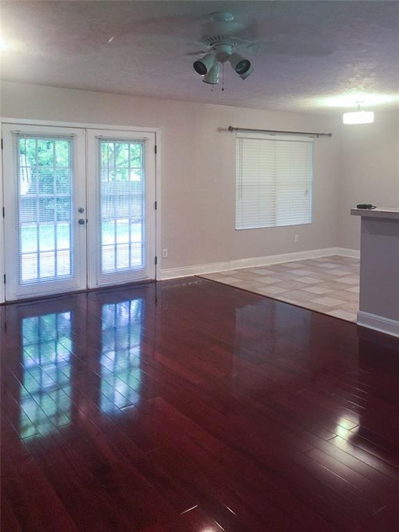 1658 Chippeway Lane Austin, TX 78745 - Photo 3 of 12 Living/Great room area has wood floors and french doors that open onto a backyard deck.