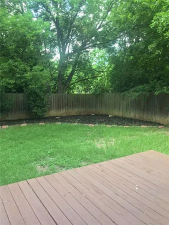 a view of a backyard with a wooden deck