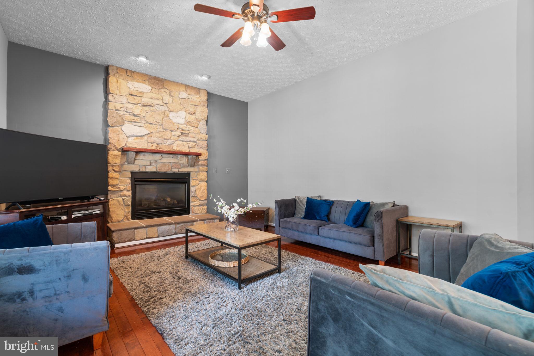 22 Dovefield Road Perry Hall, MD 21128 - Photo 14 of 46 a living room with furniture a flat screen tv and a fireplace