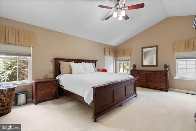 a bedroom with a bed dresser and a window