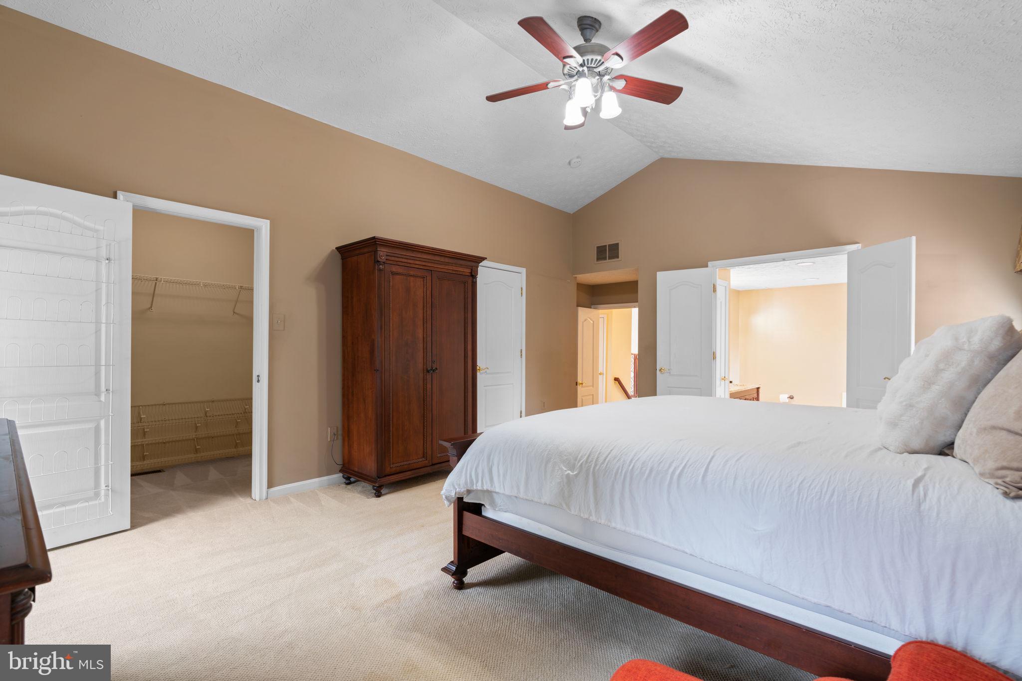 22 Dovefield Road Perry Hall, MD 21128 - Photo 22 of 46 a bedroom with a large bed and a chandelier