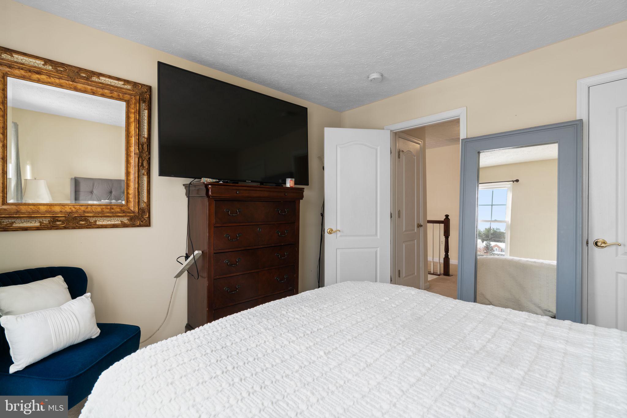 22 Dovefield Road Perry Hall, MD 21128 - Photo 32 of 46 a bedroom with a bed and a flat screen tv