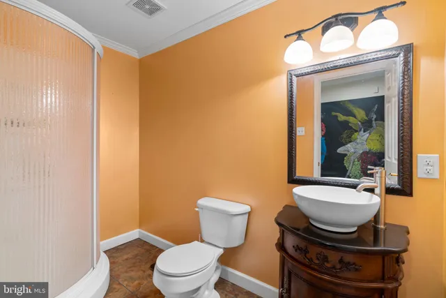 a bathroom with a toilet a sink and mirror