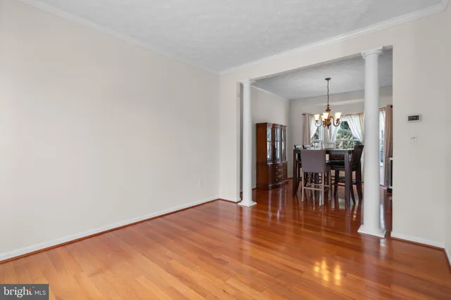 a dining room with furniture and wooden floor
