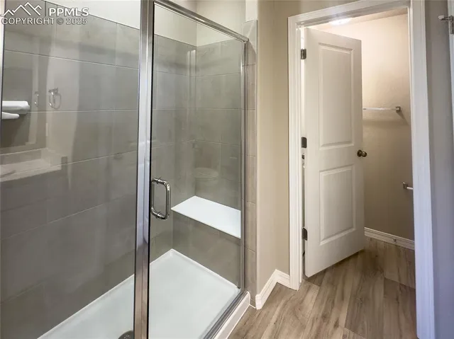 a bathroom with a sink double vanity granite tub and shower