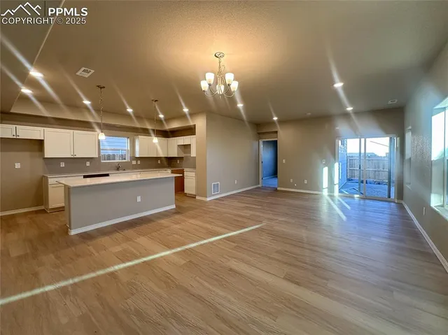 a view of a kitchen with a sink and cabinets