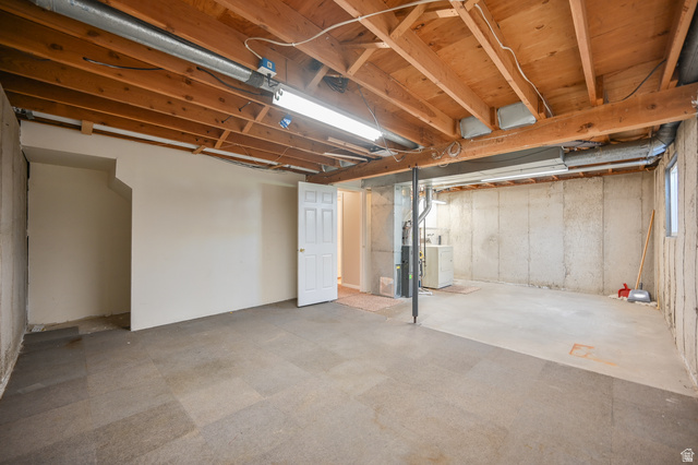 916 Vics Road, Unit 2 Sandy, UT 84094 - Photo 19 of 23 Unfinished basement offering exposed wood ceiling joists, concrete foundation walls, a utility area, and a window for natural light