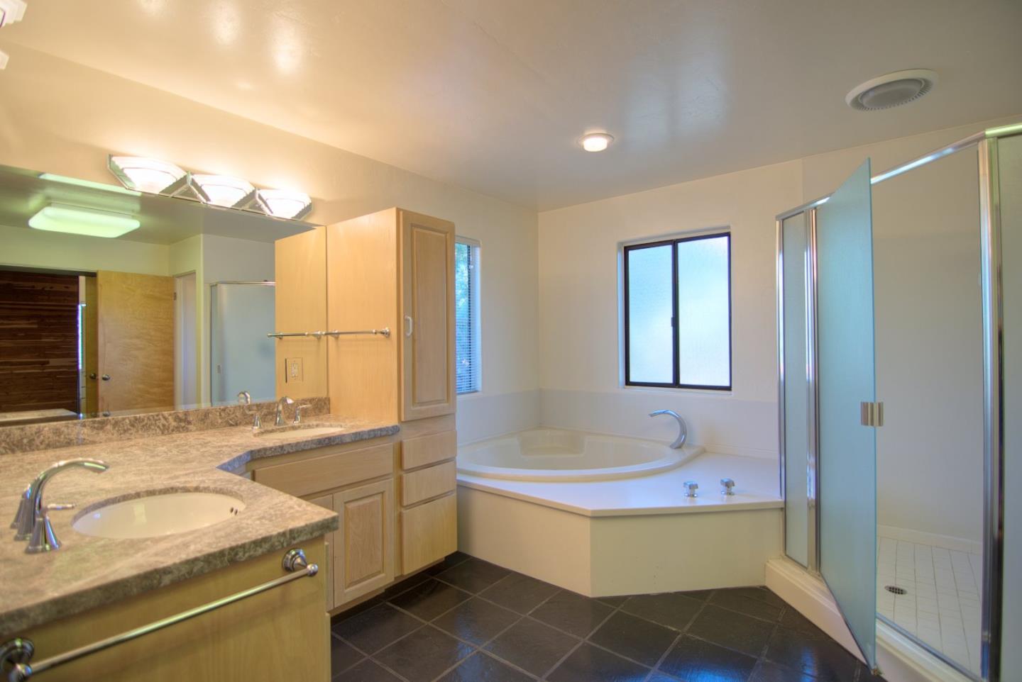 3062 Sloat Road Pebble Beach, CA 93953 - Photo 17 of 24 a bathroom with a tub sink and mirror
