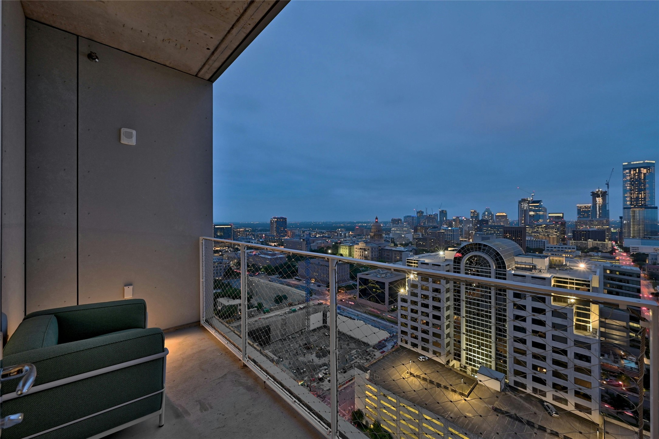 Private balcony with dramatic skyline views, perfect for evening relaxation and city lights.