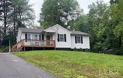 a front view of a house with a garden and trees