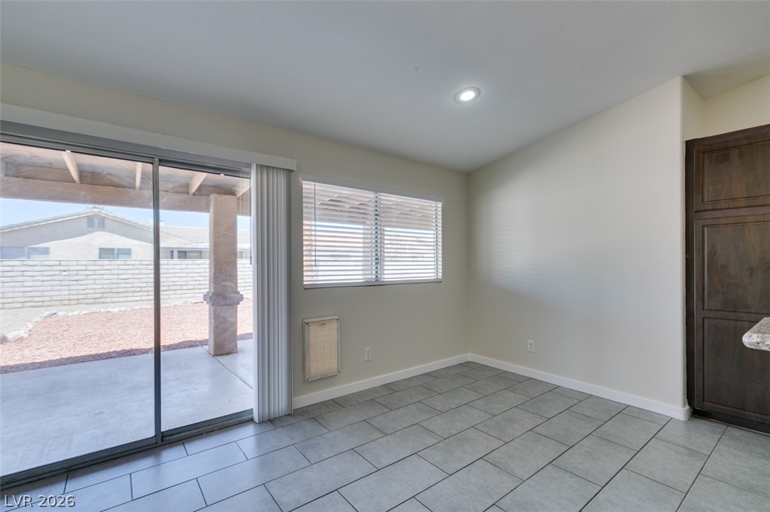 2028 Rustler Ridge Avenue North Las Vegas, NV 89031 - Photo 14 of 40 Sliding glass doors open to a generous patio, inviting indoor-outdoor living.