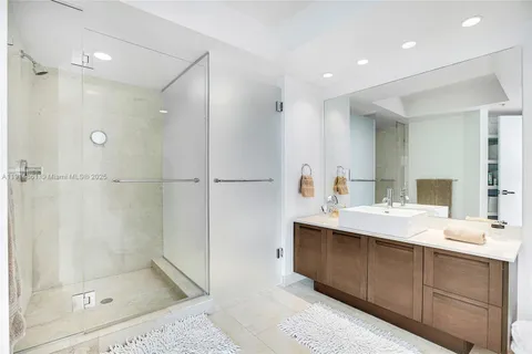 a bathroom with a shower sink and mirror