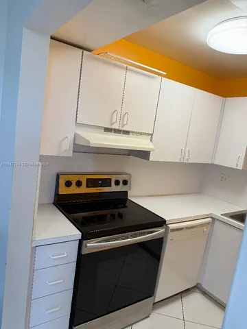 a stove top oven sitting inside of a kitchen
