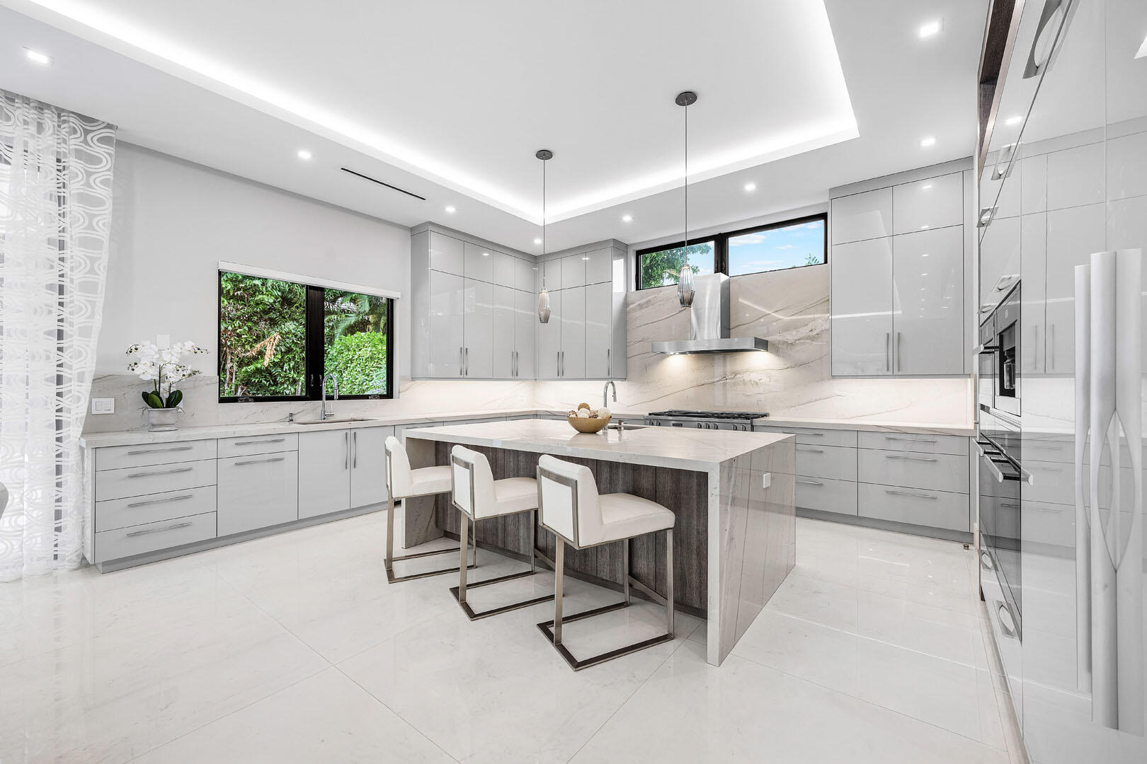 2391 Areca Palm Road Boca Raton, FL 33432 - Photo 22 of 82 a kitchen with kitchen island a counter top space a sink stainless steel appliances and cabinets