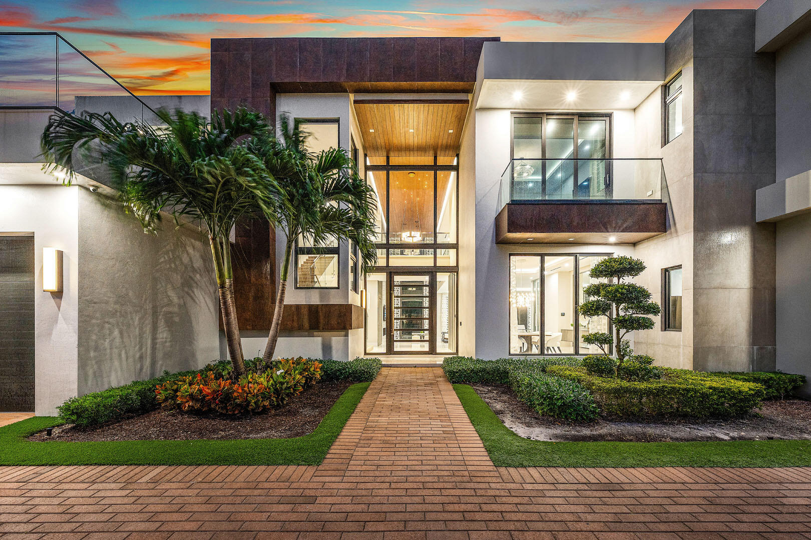 2391 Areca Palm Road Boca Raton, FL 33432 - Photo 5 of 82 a front view of a house with a yard and potted plants
