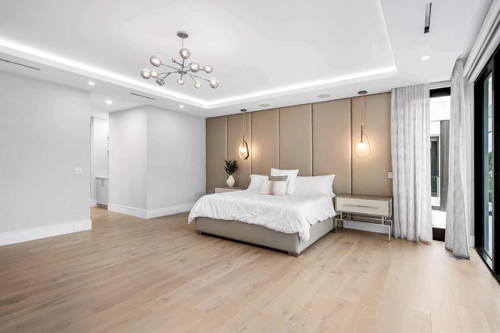 2391 Areca Palm Road Boca Raton, FL 33432 - Photo 54 of 82 a spacious bedroom with a large bed and a chandelier