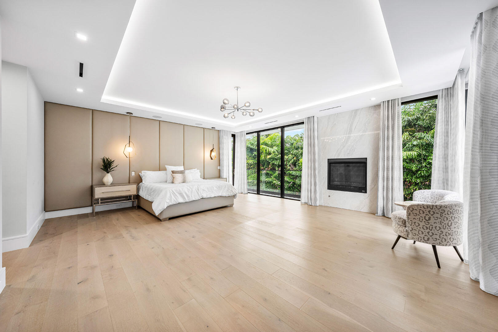 2391 Areca Palm Road Boca Raton, FL 33432 - Photo 55 of 82 a spacious bedroom with a large bed and a chandelier