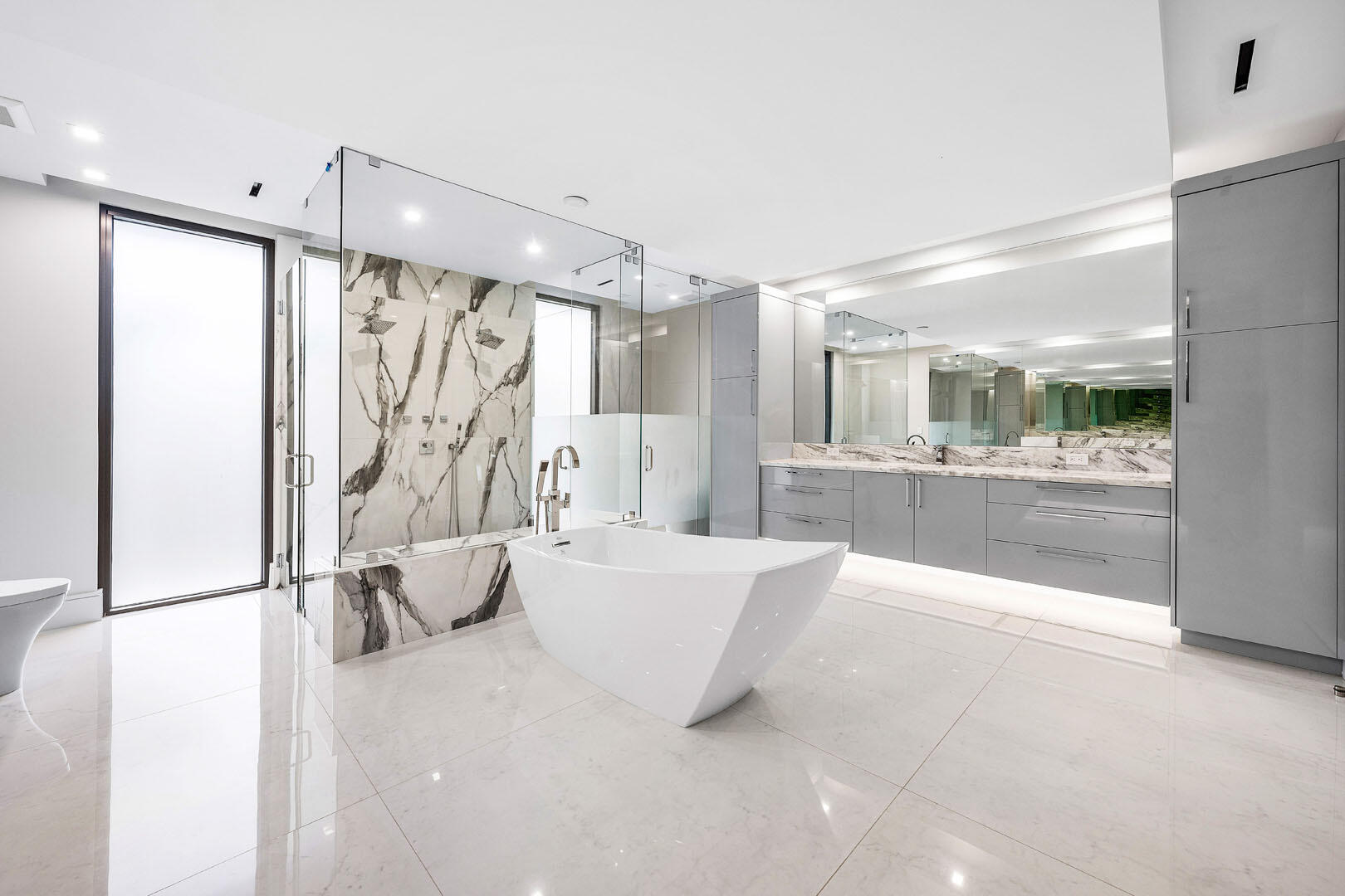 2391 Areca Palm Road Boca Raton, FL 33432 - Photo 58 of 82 a large white tub sitting in a bathroom and a shower
