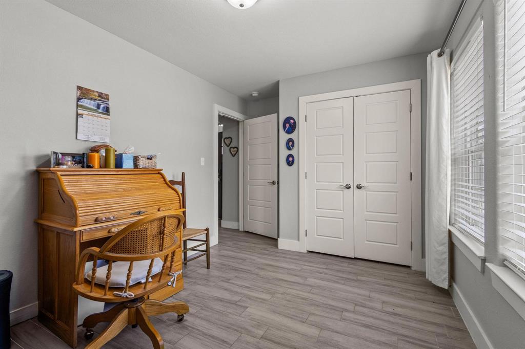 608 East Shepherd Street Denison, TX 75021 - Photo 23 of 31 Room featuring light gray walls, wood-finish plank flooring, and white trim
