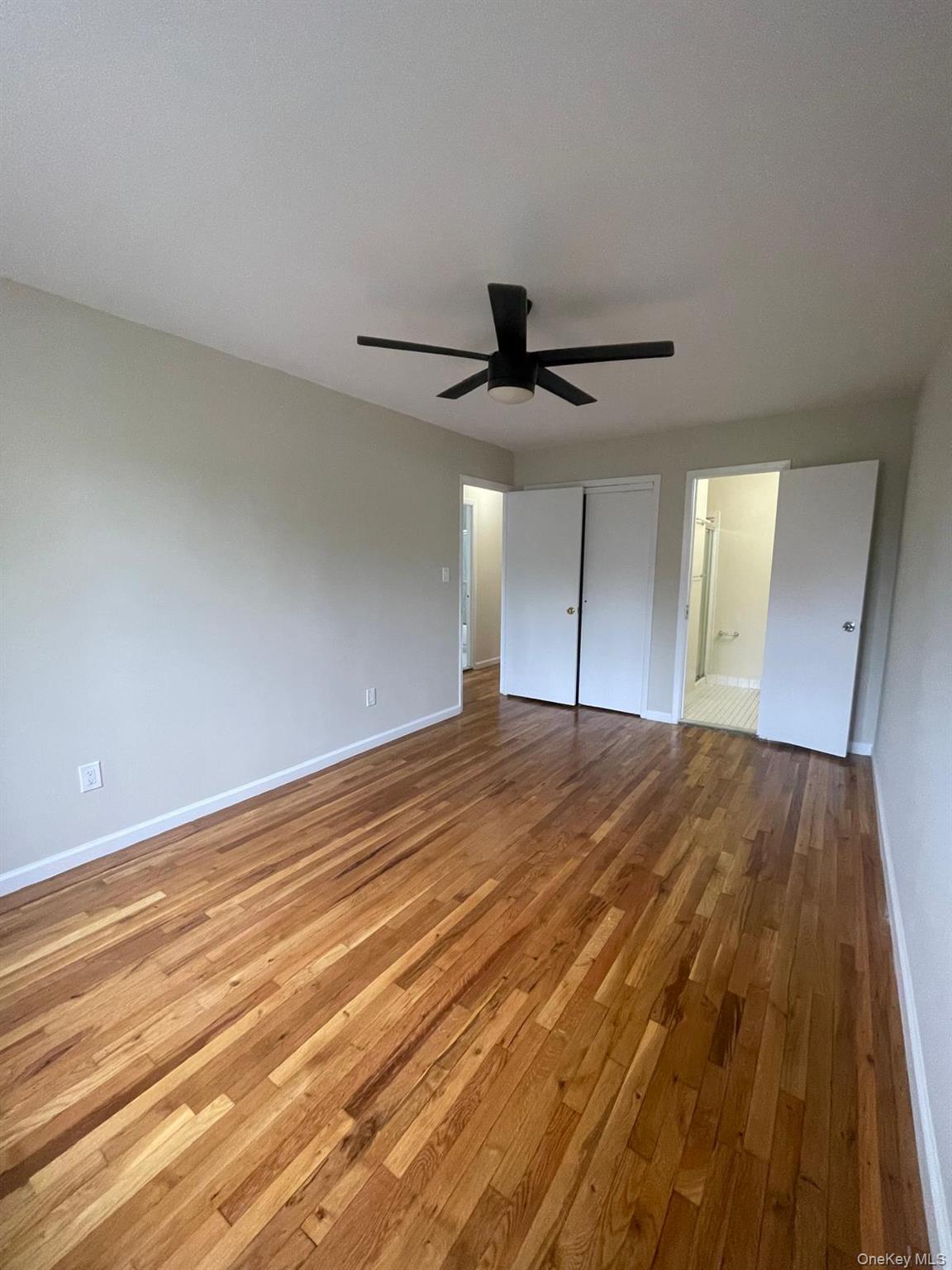 110-21 55th Avenue Queens, NY 11368 - Photo 19 of 29 a view of empty room with wooden floor and fan