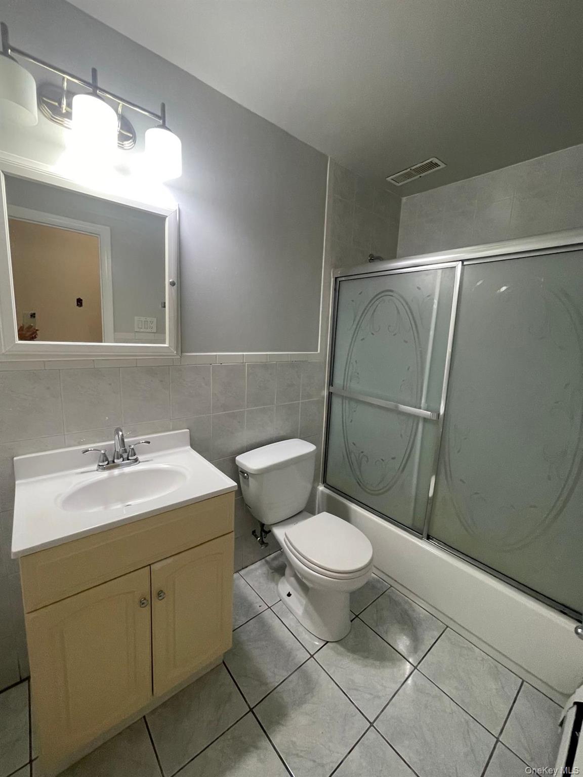 110-21 55th Avenue Queens, NY 11368 - Photo 22 of 29 a bathroom with a sink toilet and mirror