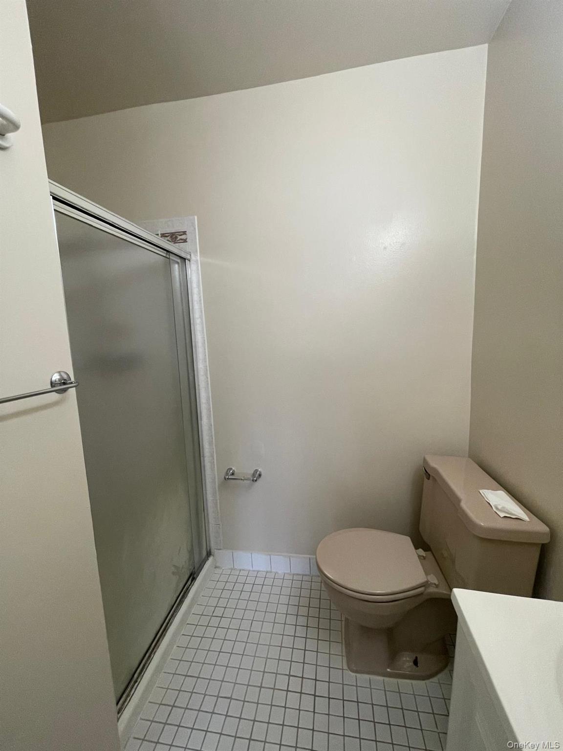 110-21 55th Avenue Queens, NY 11368 - Photo 23 of 29 a bathroom with a toilet and a shower
