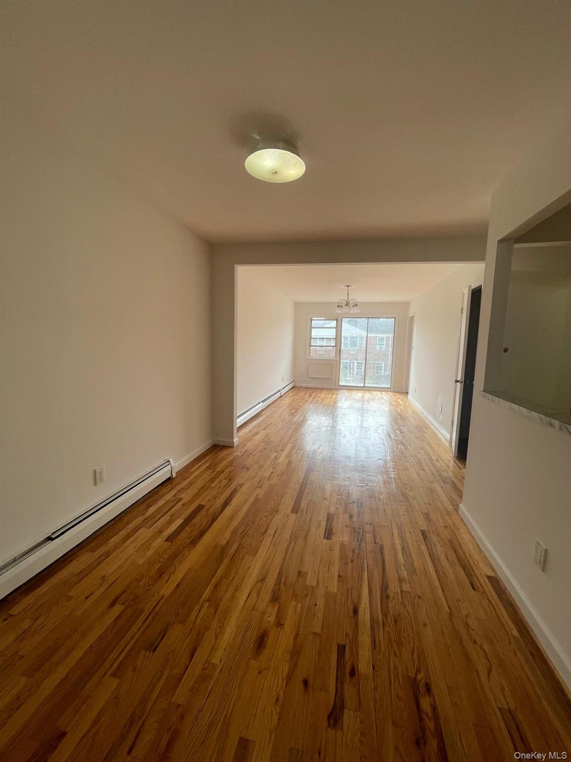 110-21 55th Avenue Queens, NY 11368 - Photo 29 of 29 wooden floor in an empty room with a window