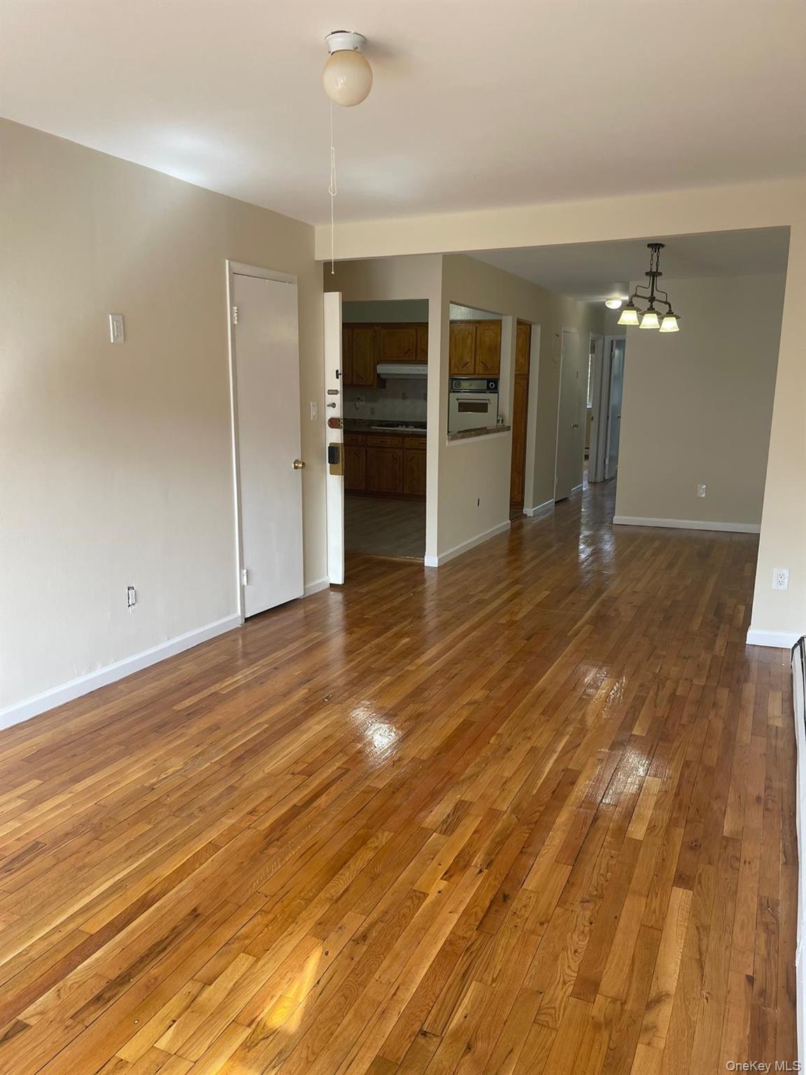 110-21 55th Avenue Queens, NY 11368 - Photo 6 of 29 wooden floor in an empty room