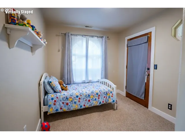 a bedroom with bed and a window