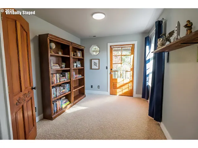 a view of an empty room with window and workspace
