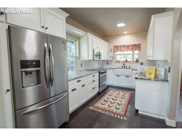 a kitchen with stainless steel appliances a refrigerator sink and cabinets