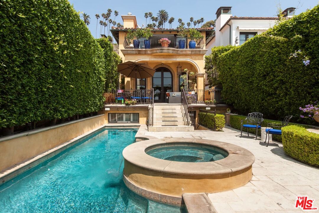 an aerial view of a house with garden swimming pool and outdoor seating
